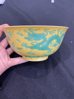 Lot 663 - A CHINESE GREEN-ENAMELLED YELLOW-GROUND 'DRAGON AND PHOENIX' BOWL.