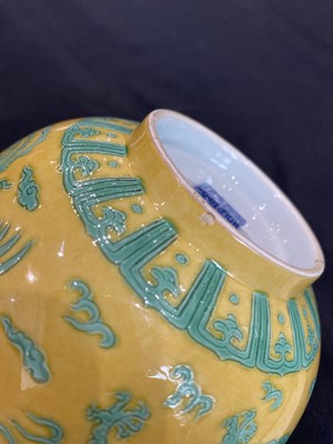 Lot 663 - A CHINESE GREEN-ENAMELLED YELLOW-GROUND 'DRAGON AND PHOENIX' BOWL.