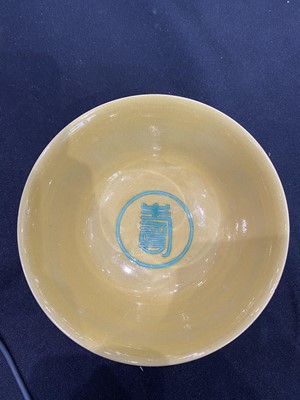 Lot 663 - A CHINESE GREEN-ENAMELLED YELLOW-GROUND 'DRAGON AND PHOENIX' BOWL.