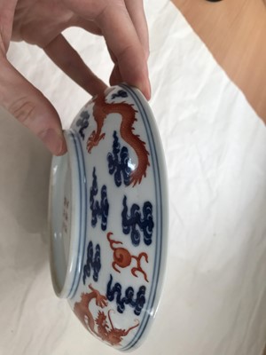 Lot 247 - A CHINESE BLUE AND WHITE AND IRON-RED 'DRAGON' DISH.