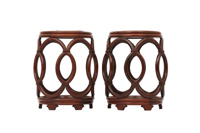 Lot 284 - A PAIR OF CHINESE WOOD RETICULATED BARREL STANDS.