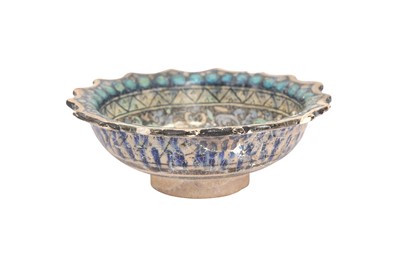 Lot 214 - AN ILKHANID FOOTED POTTERY BOWL DEPICTING TWO FOXES