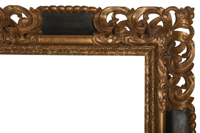 Lot 45 - A SPANISH 17TH CENTURY STYLE REVERSE PROFILE FRAME WITH CARVED, GILDED AND PIERCED CORNERS AND PAINTED SCOTIA CARTOUCHES
