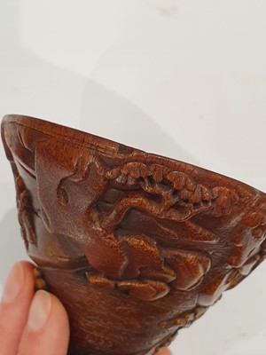 Lot 34 - A CHINESE RHINOCEROS HORN ‘RIVER LANDSCAPE’ LIBATION CUP.