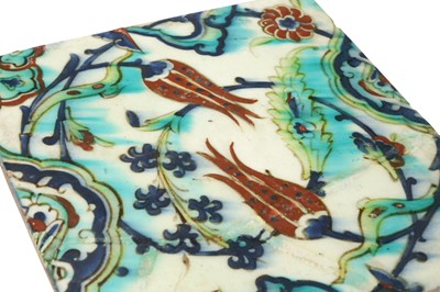 Lot 325 - AN IZNIK POTTERY TILE WITH A FLORAL SPRAY OF TULIPS, HYACINTHS AND ROSETTES
