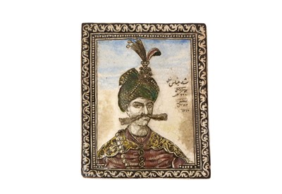 Lot 411 - A QAJAR MOULDED POTTERY TILE DEPICTING SHAH ABBAS THE GREAT