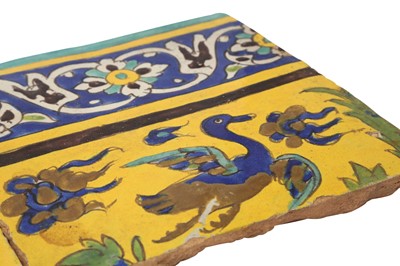 Lot 414 - THREE SAFAVID CUERDA SECA POTTERY TILES WITH ANIMALS