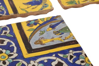 Lot 414 - THREE SAFAVID CUERDA SECA POTTERY TILES WITH ANIMALS