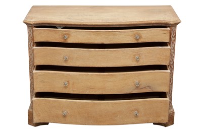 Lot 21 - AN ARTS AND CRAFTS STYLE LIMED OAK SERPENTINE CHEST OF DRAWERS