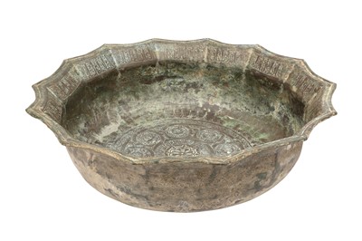 Lot 209 - A LARGE KHORASAN BRASS BASIN WITH KUFIC INSCRIPTIONS