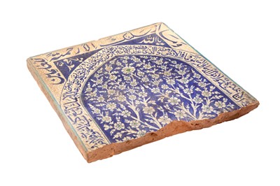 Lot 451 - A MULTAN POTTERY TILE WITH A DENSELY INSCRIBED MIHRAB