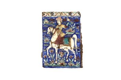 Lot 408 - A QAJAR MOULDED POTTERY TILE WITH A FALCONER