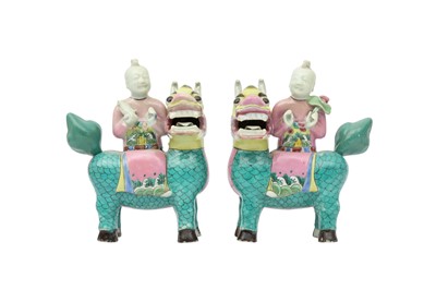 Lot 705 - A PAIR OF CHINESE FAMILLE ROSE FIGURES RIDING QILIN.
