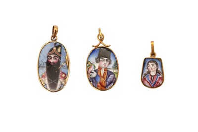 Lot 72 - A POLYCHROME-PAINTED ENAMELLED PORTRAIT PENDANT OF FATH ALI SHAH AND TWO QAJAR YOUTHS