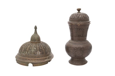 Lot 384 - A ZAND OPENWORK BRASS LID AND A QAJAR OPENWORK COPPER ALLOY VASE WITH COVER