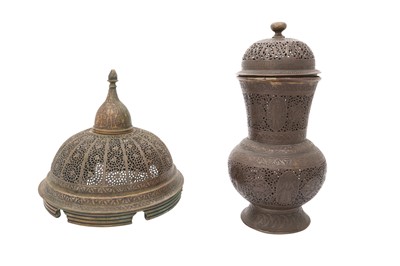 Lot 384 - A ZAND OPENWORK BRASS LID AND A QAJAR OPENWORK COPPER ALLOY VASE WITH COVER