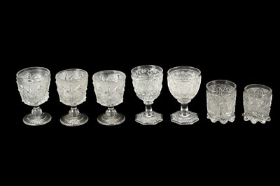 Lot 354 - A COLLECTION OF SEVEN FRENCH PRESS MOULDED DRINKING GLASSES, 19TH CENTURY