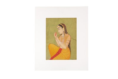 Lot 589 - A PORTRAIT OF AN INDIAN LADY HOLDING A SEED
