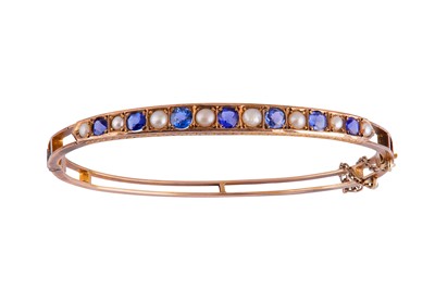 Lot 36 - A sapphire and pearl bangle
