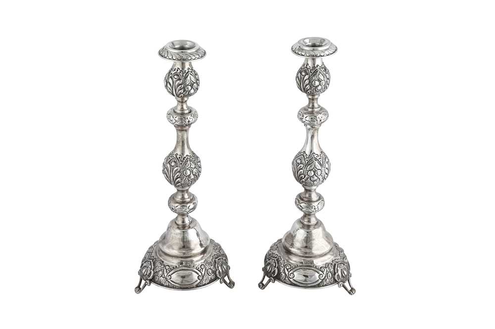 Lot 338 - Judaica - A pair of George V sterling silver sabbath candlesticks, London 1911 by Jacob Rosenzweig & Aaron Taitelbaum