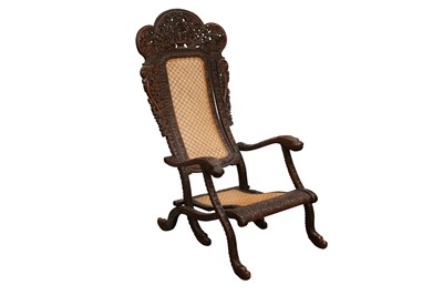 Lot 259 - AN ANGLO-INDIAN CARVED HARDWOOD FOLDING CHAIR