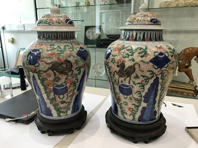 Lot 124 - A NEAR-PAIR OF CHINESE WUCAI BALUSTER 'HORSES' VASES AND COVERS.