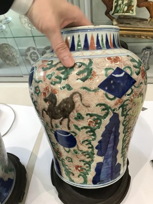 Lot 225 - A NEAR-PAIR OF CHINESE WUCAI BALUSTER 'HORSES' VASES AND COVERS.