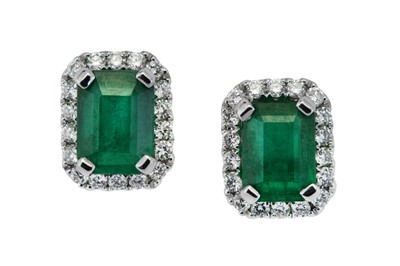 Lot 52 - A pair of emerald and diamond cluster earrings