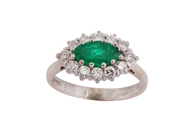 Lot 54 - An emerald and diamond cluster ring