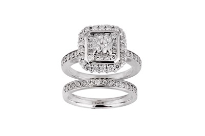 Lot 211 - A diamond and platinum engagement ring and wedding band