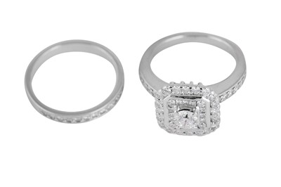 Lot 211 - A diamond and platinum engagement ring and wedding band