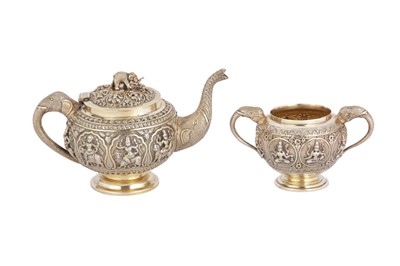 Lot 118 - A late 19th century Anglo – Indian parcel gilt silver teapot and twin handled sugar bowl, Madras circa 1880