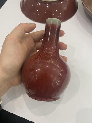 Lot 80 - A CHINESE COPPER RED-GLAZED BOTTLE VASE AND DISH.