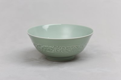 Lot 85 - A CHINESE CELADON-GLAZED MOULDED BOWL.