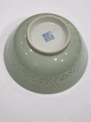 Lot 85 - A CHINESE CELADON-GLAZED MOULDED BOWL.