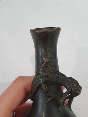 Lot 666 - A CHINESE BRONZE 'LIU HAI' CANDLE STICK AND A SMALL VASE.