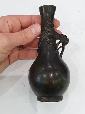Lot 666 - A CHINESE BRONZE 'LIU HAI' CANDLE STICK AND A SMALL VASE.