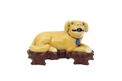 Lot 206 - A CHINESE YELLOW-GLAZED MODEL OF A RECUMBENT DOG