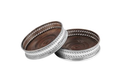 Lot 610 - A pair of George III sterling silver wine coasters, London 1782 possibly by Robert Hennell I