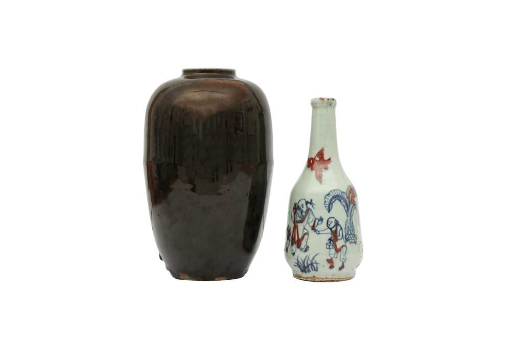 Lot 540 - A CHINESE MIRROR BLACK GLAZED JAR AND A BLUE AND WHITE AND COPPER RED GLAZED 'BOYS' VASE.