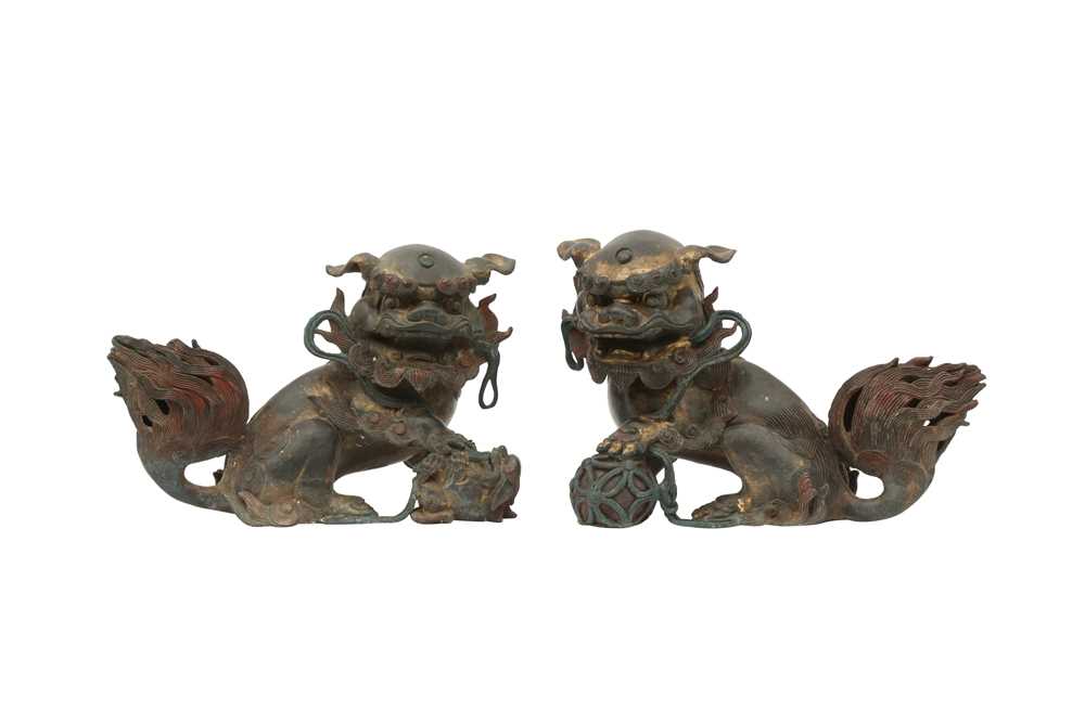 Lot 576 - A PAIR OF CHINESE GILT-BRONZE LION DOGS.