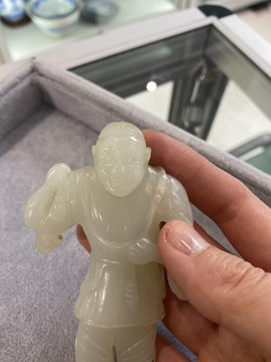 Lot 187 - A CHINESE CARVED JADE FIGURE OF A MAN.