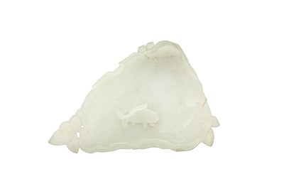 Lot 180 - A CHINESE CARVED JADE ‘LOTUS LEAF’ WASHER.