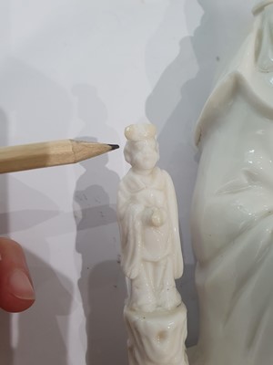 Lot 55 - A CHINESE BLANC-DE-CHINE 'GUANYIN AND CHILD' GROUP.