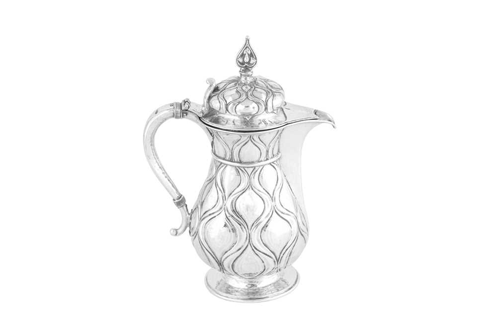 Lot 440 - A George V ‘Arts and Crafts’ sterling silver hot water pot, London 1923 by Omar Ramsden (1873-1939)