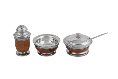 Lot 435 - A George V 'Arts and Crafts' sterling silver mounted birch wood three-piece cruet set, London 1935 by Henry George Murphy (1884-1939)
