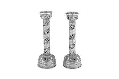 Lot 248 - A pair of mid-20th century Tibetan unmarked silver picket candlesticks, circa 1950