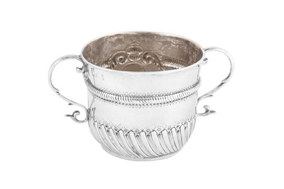 Lot 687 - A William III Britannia standard silver twin handled porringer or cup, London 1700 by Edward Wimans