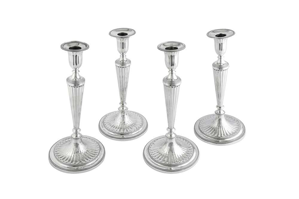 Lot 696 - A closely matched set of four George III sterling silver candlesticks, London 1782/83 by John Scofield (reg. 13th Jan 1778)