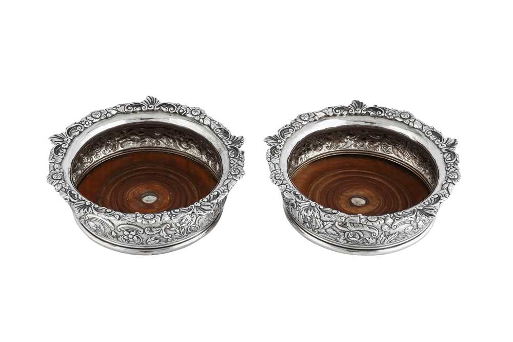Lot 611 - A pair of George III sterling silver wine coasters, London 1818 by Thomas Robins